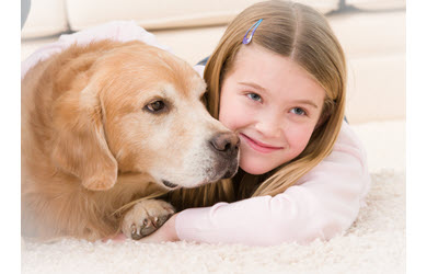best carpet cleaner for pet messes, dog and girl snuggle on carpet