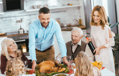 family sitting around a holiday dinner table