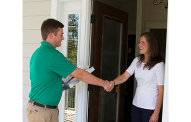 carpet cleaner greets customer at door and shakes hand