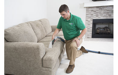 upholstery cleaning being performed on a sofa