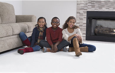 kids sitting on clean carpet after affordable carpet cleaning from Chem-Dry