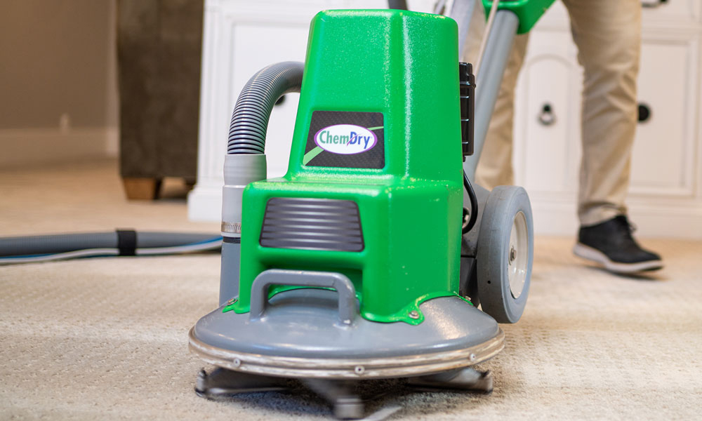 Powerhead on carpet being cleaned by technician