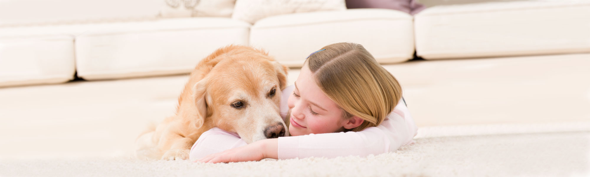 Girl laying on clean carpet with Dog