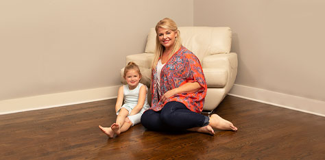 Mom and child site on nice clean wood floor