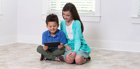 Kids sit on clean tile floor