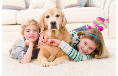 kids with dog on rug