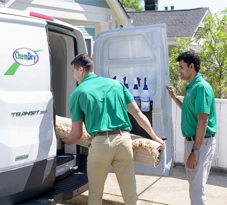 Techs loading rug into van