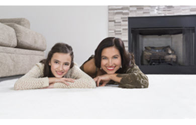 mom and daughter relax on clean carpet