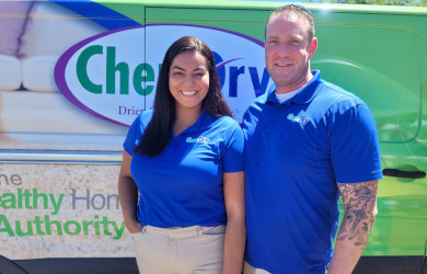 Golden Chem-Dry van with owners standing in front