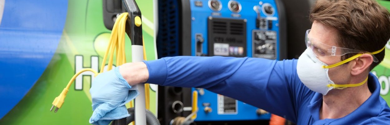 Chem-Dry employee wipes down equipment