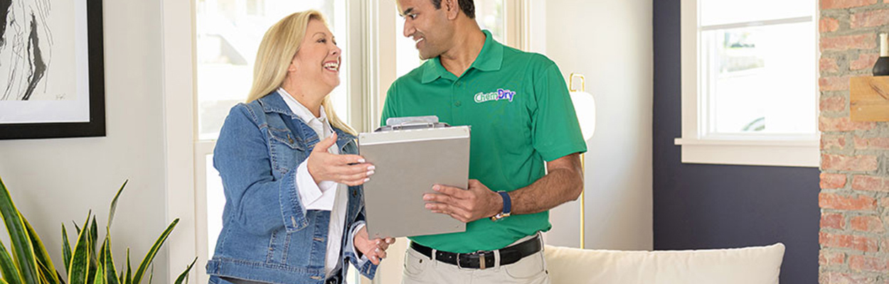 Chem-Dry technician standing with smiling client