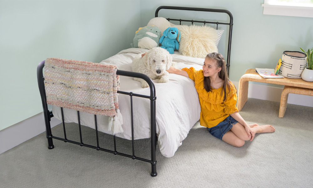 Girl sitting next to dog