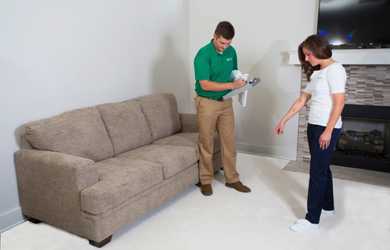 homeowner points out spot to professional carpet cleaning tech