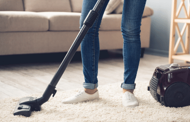 woman vacuuming carpet